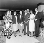 Two Flight Attendants and Airplane Pilot Pose with Others, B by George Skip Gandy IV