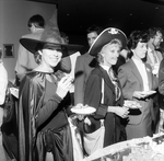 A Woman Dressed as a Witch Smiles in the Buffet Line by George Skip Gandy IV