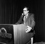 A Man in a Suit and Tie Gives a Speech at Harbour Island Hotel by George Skip Gandy IV