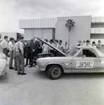 John S. Allen and Engineering Students Examine Clean Air Race Vehicle, C by George Skip Gandy IV