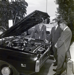 Three Individuals at City Hall Inspect Under Hood of Dancey Co Clean Air Car, A by George Skip Gandy IV