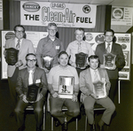 Group Photo of Seven Dancey Co Employees Holding Plaques, A by George Skip Gandy IV