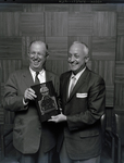 Two Men Holding an Award by George Skip Gandy IV