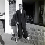 Man in a Suit and Cast Posing Near a Brick Wall, B by George Skip Gandy IV