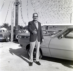 Car Dealer in Front of Car by George Skip Gandy IV