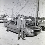 Auto Dealer in Front of Car by George Skip Gandy IV