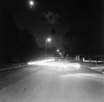 Nighttime Street Scene with a Car and Light Trails, A by George Skip Gandy IV