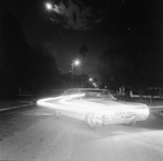 Nighttime Street Scene with a Car and Light Trails, C by George Skip Gandy IV