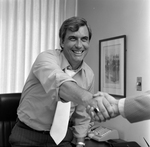 Man Shaking Hands in Office, Tampa, Florida, A by George Skip Gandy IV