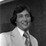 Smiling Man in Suit and Patterned Tie, B by George Skip Gandy IV