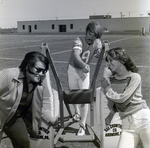 Two Women with Boy on Football Sled, B by George Skip Gandy IV