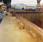 Person Inspecting Ship with a Handheld Radio by George Skip Gandy IV