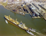 Damaged Banlar Baani Carrier with Tugboat Assistance at a Shipyard and Repair Facility, C by George Skip Gandy IV