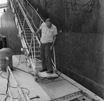 Person Inspecting Metal Equipment Invovled in an Accident, F by George Skip Gandy IV