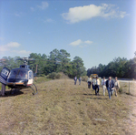 Businesspeople Walk by Helicopter in Field for M-C Development, A by George Skip Gandy IV