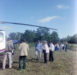 Businesspeople Gather by Helicopter in Field for M-C Development, A by George Skip Gandy IV