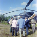 Businesspeople Gather by Helicopter in Field for M-C Development, B by George Skip Gandy IV