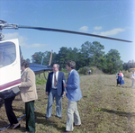 Businesspeople Gather by Helicopter in Field for M-C Development, C by George Skip Gandy IV