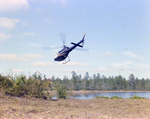 Helicopter Flying over Field for M-C Development, D by George Skip Gandy IV