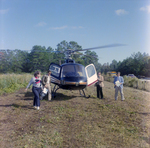 Businesspeople Walk by Helicopter in Field for M-C Development, G by George Skip Gandy IV