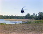 Helicopter Flying over Field for M-C Development, E by George Skip Gandy IV