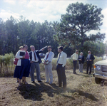 Businesspeople Stand in Field for M-C Development, J by George Skip Gandy IV