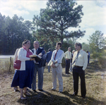 Businesspeople Stand in Field for M-C Development, K by George Skip Gandy IV