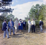 Businesspeople Stand in Field for M-C Development, M by George Skip Gandy IV