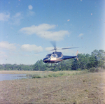 Helicopter Flying over Field for M-C Development, F by George Skip Gandy IV