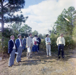 Businesspeople Stand in Field for M-C Development, N by George Skip Gandy IV