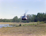 Helicopter Flying over Field for M-C Development, G by George Skip Gandy IV