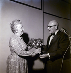 Woman Receiving Flowers During Award Dinner for Representative Sam Gibbons by George Skip Gandy IV