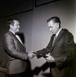 Man Accepts Award During Award Dinner for Representative Sam Gibbons by George Skip Gandy IV