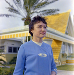 Woman Outside Yellow A-frame Home for Midland-Guardian of Tampa, A by George Skip Gandy IV