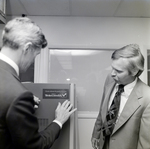 Men Applying a Telecredit Sticker for Master Charge, B by George Skip Gandy IV