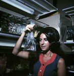 Woman Holding Bag of Fish for Master Packaging, B by George Skip Gandy IV