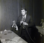 Man Speaking at Table for Aero Mayflower Transit Company Incorporated, C by George Skip Gandy IV