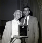Man and Woman Standing with Plaque at Memorial Hospital in Tampa, A by George Skip Gandy IV
