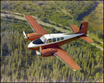 Twin Bonanza Plane Flies Over Marsh Landscape in Opa-locka, Florida, P