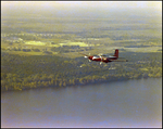 Twin Bonanza Plane Flies Over Coastline in Opa-locka, Florida, C