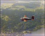 Twin Bonanza Plane Flies Over Coastline in Opa-locka, Florida, D