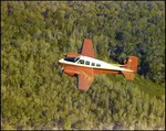 Twin Bonanza Plane Flies Over Marsh Landscape in Opa-locka, Florida, U