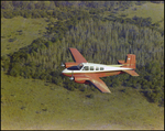 Twin Bonanza Plane Flies Over Marsh Landscape in Opa-locka, Florida, V