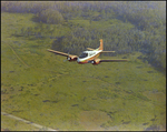 Twin Bonanza Plane Flies Over Marsh Landscape in Opa-locka, Florida, AB