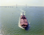 Tugboat Dixie Commander Pushing a Dredge from the Sunshine Skyway Bridge, Tampa Bay, Florida by George Skip Gandy IV