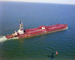 Tugboat Dixie Commander Pushing a Dredge in Tampa Bay, Florida by George Skip Gandy IV