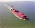 Tugboat Dixie Commander Pushing a Dredge on Open Waters, Tampa Bay, Florida, A by George Skip Gandy IV