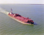 Tugboat Dixie Commander Pushing a Dredge on Open Waters, Tampa Bay, Florida, B by George Skip Gandy IV