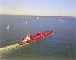 Tugboat Dixie Commander Pushing a Dredge Toward the Sunshine Skyway Bridge, Tampa Bay, Florida, B by George Skip Gandy IV