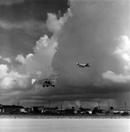 Biplane and Commercial Airplane in Flight Over Runway, Tampa, Florida, B by George Skip Gandy IV